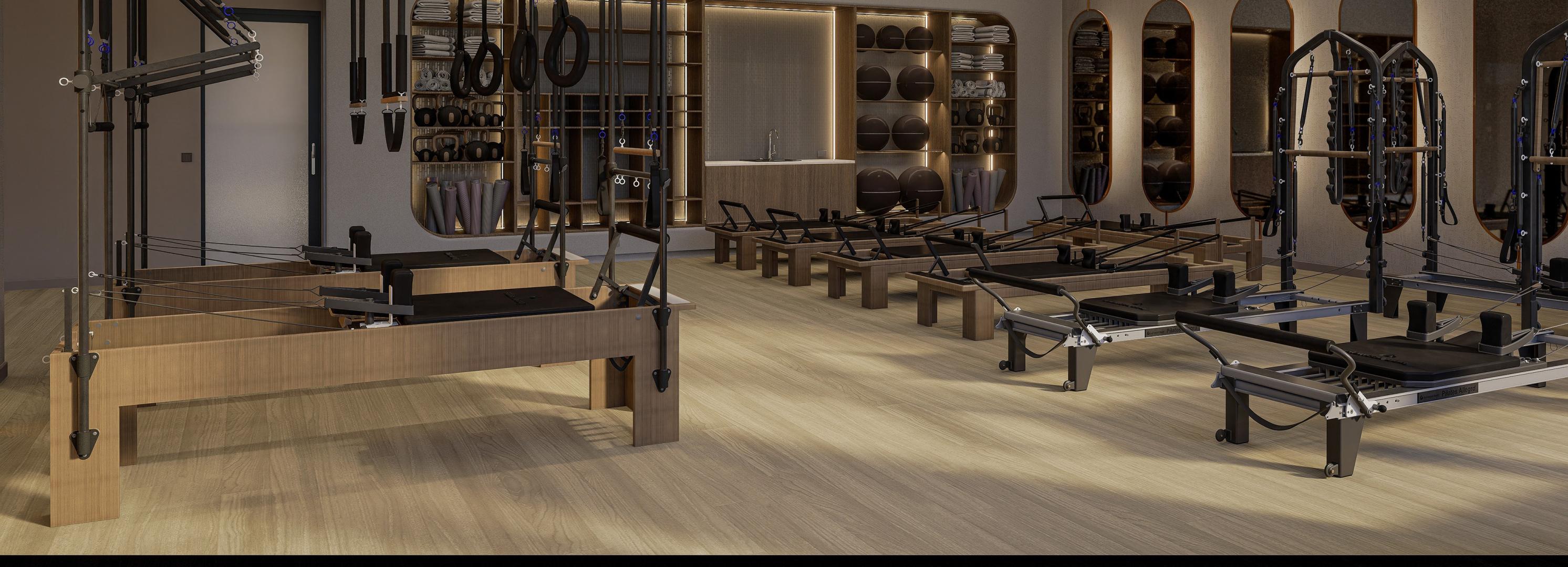 A shot of a line of pilates machines on top of Solace flooring